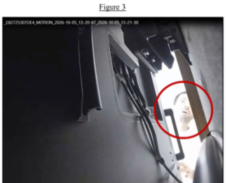 Surveillance image showing a man allegedly examining the area behind a television.