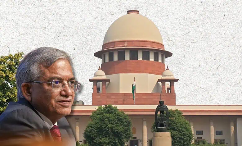 Supreme Court of India with a senior official in front, clear sky, and greenery.
