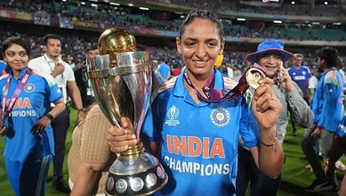 Harmanpreet Kaur holding ICC trophy and medal after winning cricket World Cup.