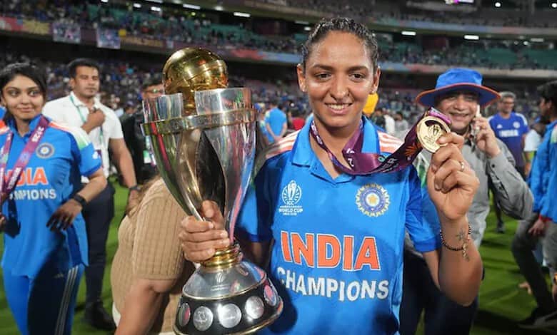 Harmanpreet Kaur holding ICC trophy and medal after winning cricket World Cup.