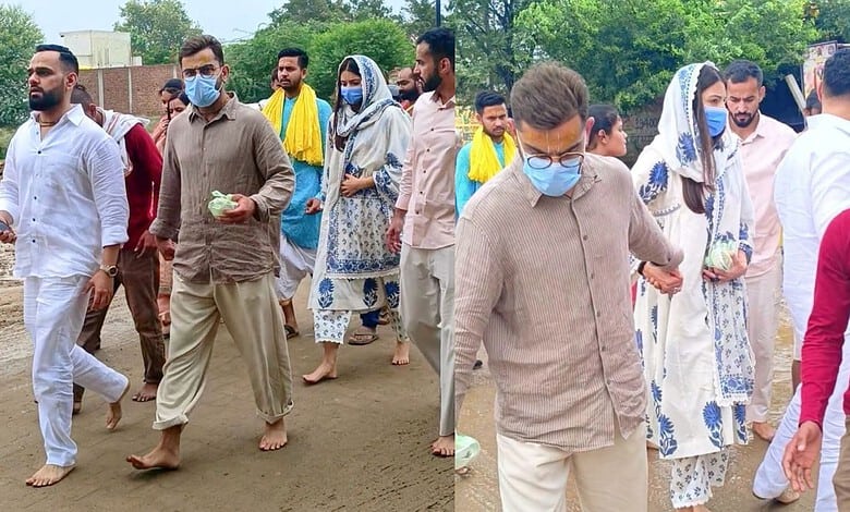 Group of people walking outdoors wearing masks and traditional attire.