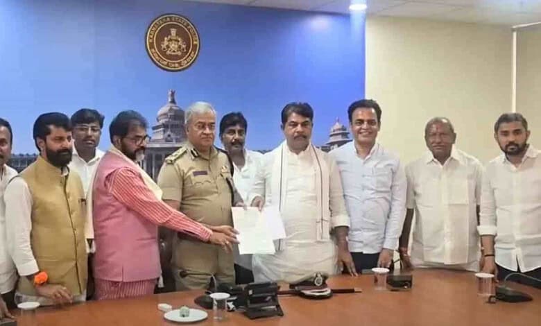 Group of men, including police officer, at a formal meeting in a conference room.