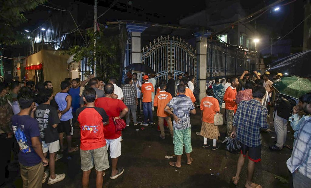 Crowd gathered outside gate during Kolkata Durga Puja stampede incident.