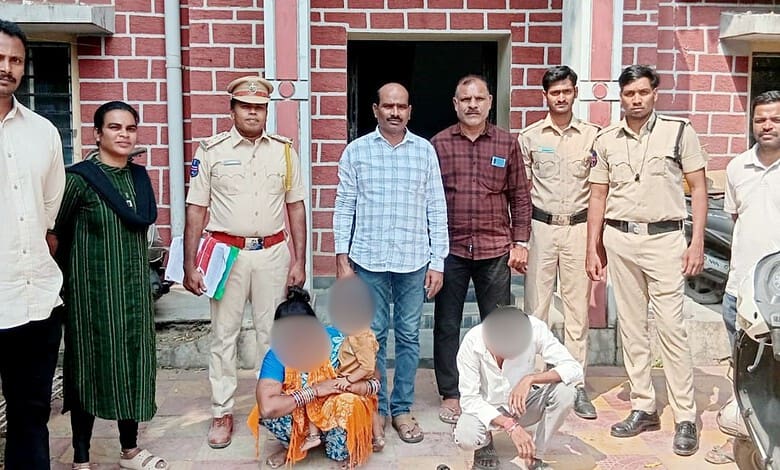 Group of police officers and individuals outside a building in Hyderabad's Dhoolpet.
