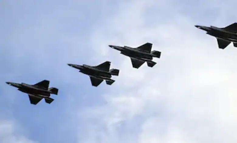 Four fighter jets flying in formation against a cloudy sky.