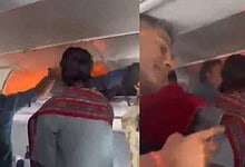 Passengers evacuate an airplane after a fire caused by a power bank on board.