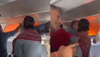 Passengers evacuate an airplane after a fire caused by a power bank on board.