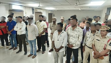 Group of men, including police officers, attending a meeting in a conference room.