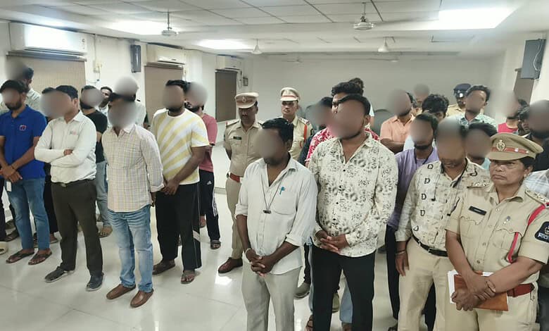 Group of men, including police officers, attending a meeting in a conference room.