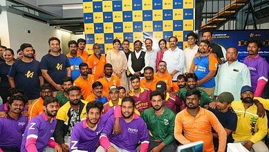 Group photo of diverse athletes and officials at TGPWU event with colourful team jerseys.