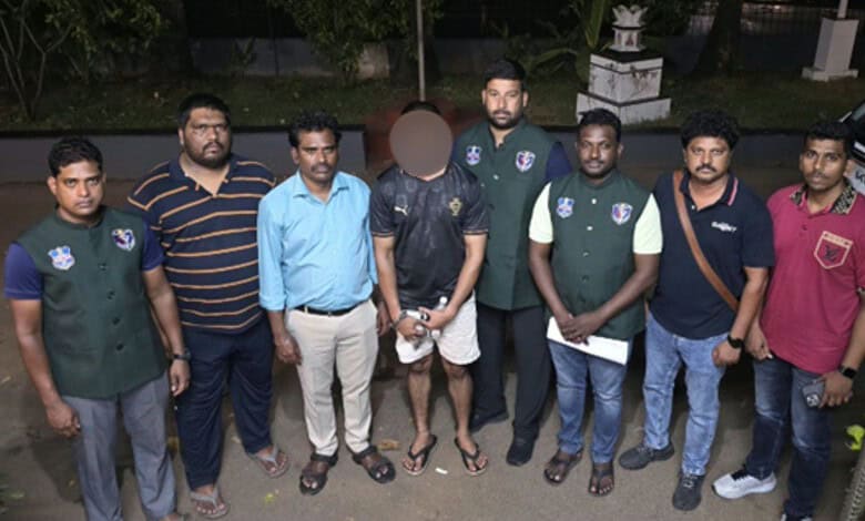 Police officers and suspect in drug bust operation, Goa-Hyderabad network, arrest scene.