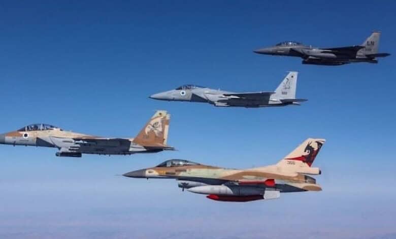 Israeli fighter jets flying in formation in clear blue sky.