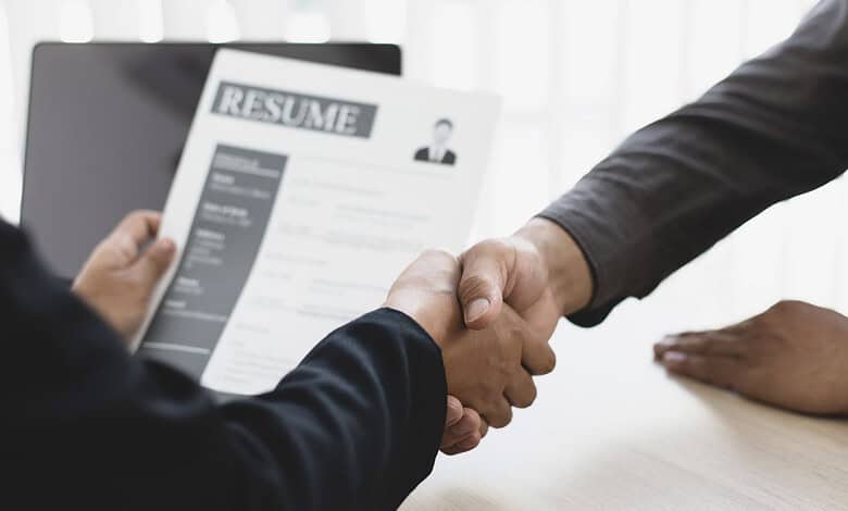 Handshake between a job seeker and interviewer during a resume interview at a professional setting.