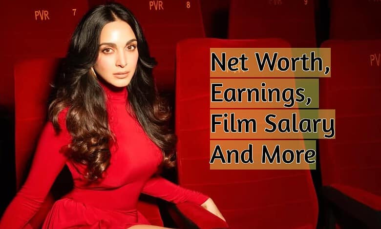 Kiara Advani in a red dress at an event with a backdrop about net worth and earnings.