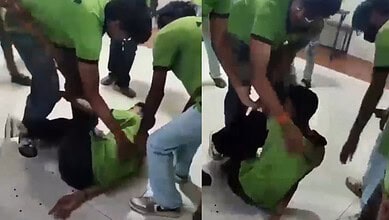 People rescuing a person trapped under a green bag at Siasat Daily office.