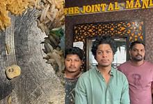 Three men stand outside a restaurant named The Joint Al-Mand with rice and a tooth on the table.