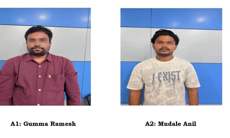 Two men, Gumma Ramesh and Mudale Anil, standing against a blue and white wall.