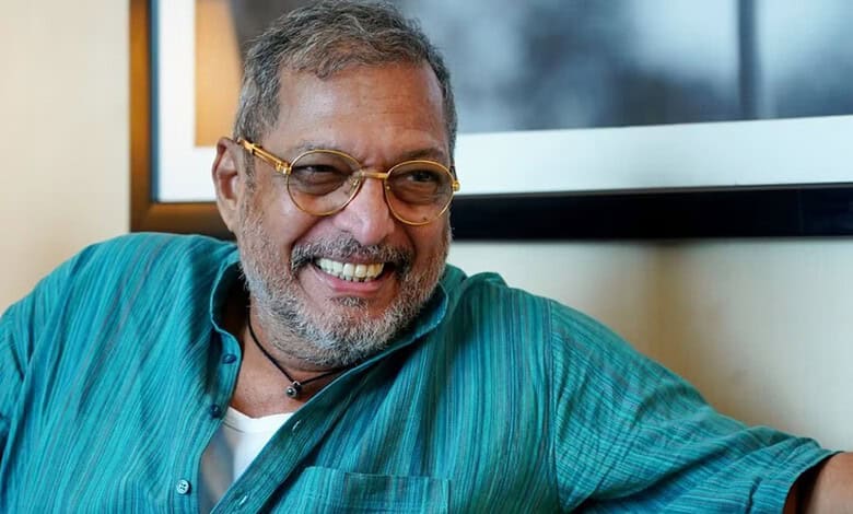 Nana Patekar smiling in a casual setting with glasses and a turquoise shirt.