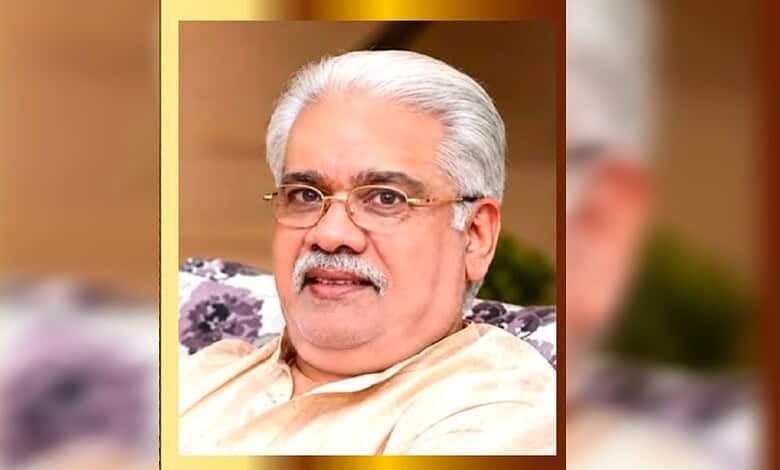 Respected Indian education leader in Kuwait with white hair and glasses, smiling in traditional attire.