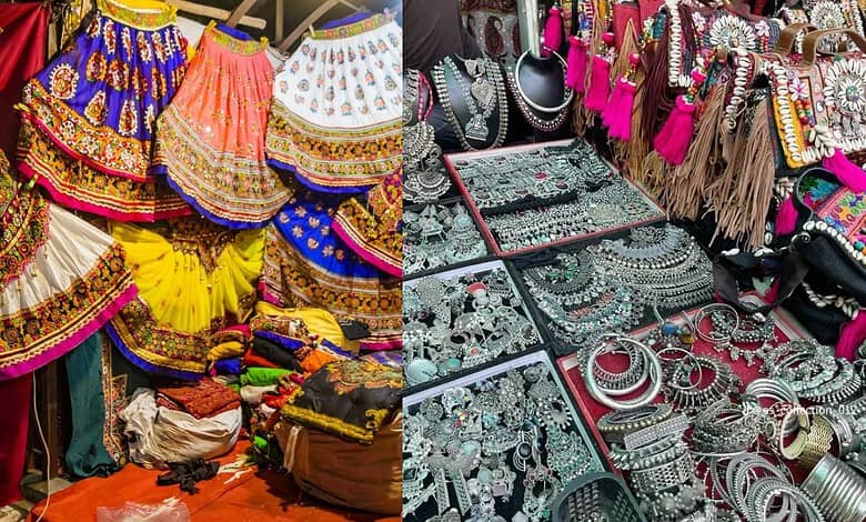Colorful traditional Indian jewelry and clothing displayed at a market stall.