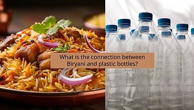Biryani dish with onions and herbs next to plastic water bottles.