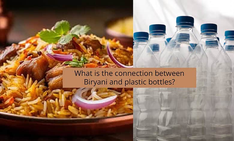 Biryani dish with onions and herbs next to plastic water bottles.