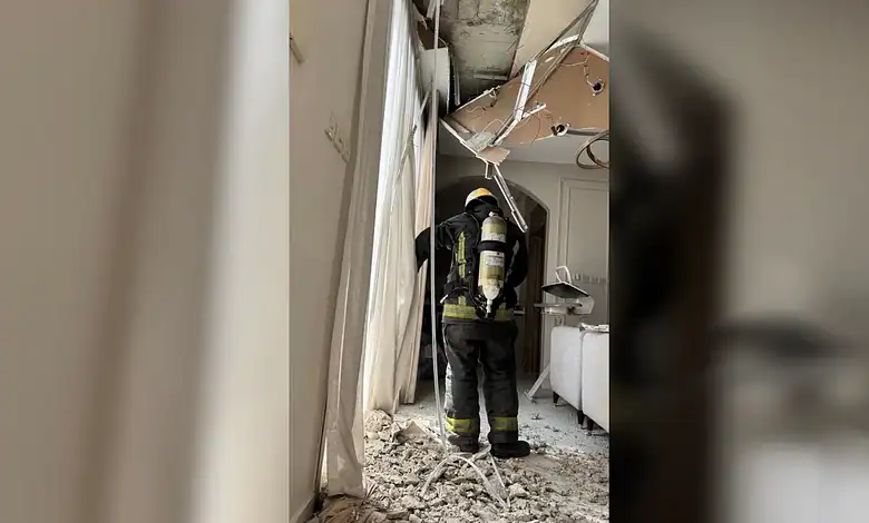Firefighter inspecting damage after missile debris impact in Riyadh.