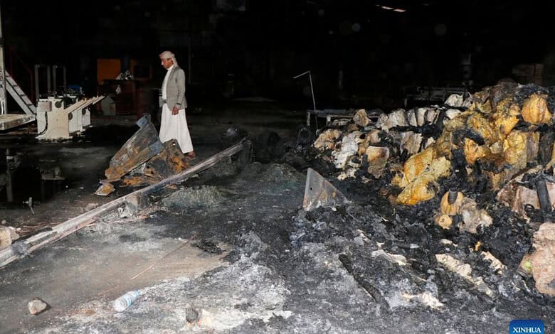 Person inspecting damage at a site with debris and burnt materials after strikes.