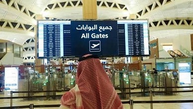 Flight information display at Riyadh airport showing all gates and flight details.