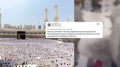 Large congregation of worshippers praying at Makkah's Grand Mosque, Saudi Arabia, with minarets in the背景.