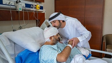 Doctor examining an Indian patient with head injury in hospital room.
