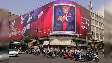 Large billboard in Tehran depicting Donald Trump with a serious expression, surrounded by Iranian text.