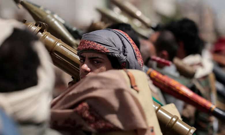 Houthi fighters in Yemen armed with rifles and wearing traditional head coverings.
